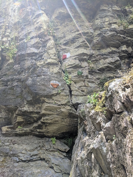 Gym holds were bolted on (unknown who) which aid moving up onto the slab on the right.
