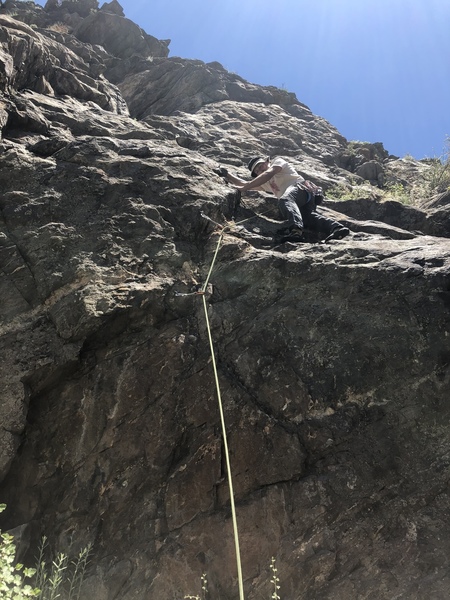 Above the second bolt.