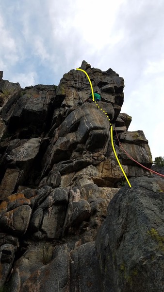 Climber on ledge below crux of pitch. Standard chimney 5.7 finish to the left.