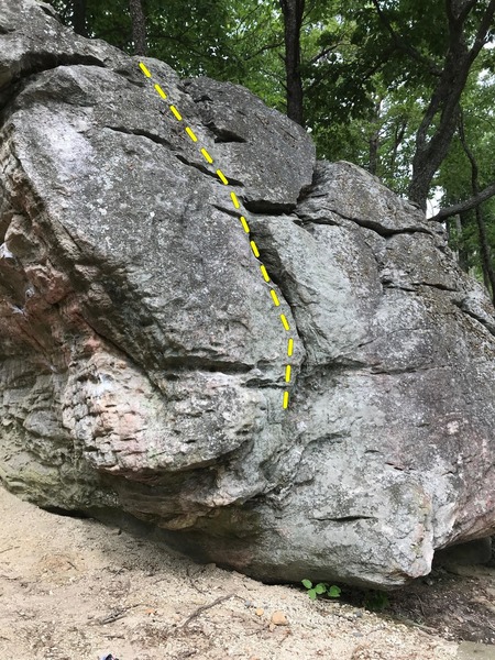 On the side opposite of the trail, theres a 3-4 move slabby boulder that goes up the crack and to the left (not the right seam). Best to have a spot so you don't tumble down the mountain if you fall. Feels like a V0 or V1.