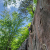 Climbs the wide crack on the left then traverse ledge and up the face to the right of the pine tree