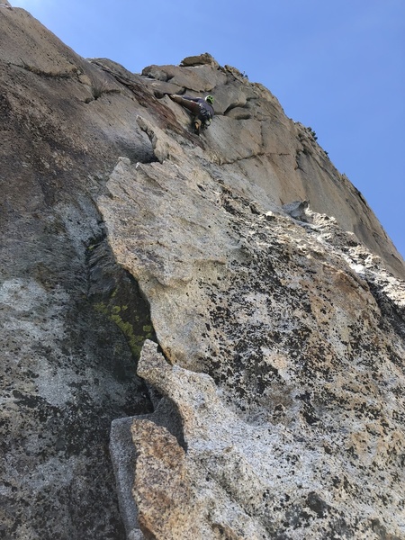 Evan heading up to the twin cracks, belaying from big flake with horns.