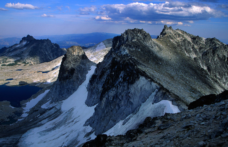 Discovering we might have made a mistake not bringing an axe or crampons - August 2004. But we were able to squeeze into the gap between snow and the grey rock, downclimb a bit and leave two wires on a rap that got us over the bare ice on the slope below.