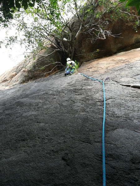 Sunny leading P1. His choice of belay station was about 20 feet past the roof crack, making the first pitch about 30m.