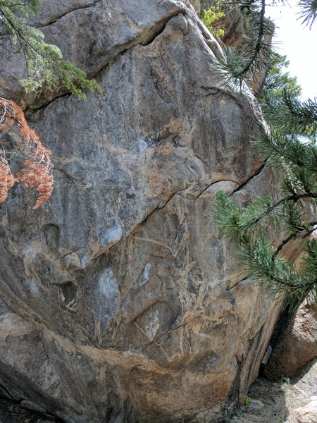 Business section of Ineditable. The crux is about 2/3 way up getting into the dark crescent-shaped hold just below the hole/mouth feature.