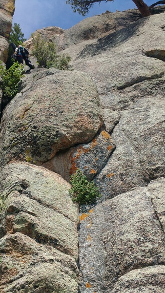 DESCENT: downclimb a groove, Class 4.The rap tree can be seen in top right of the pic.