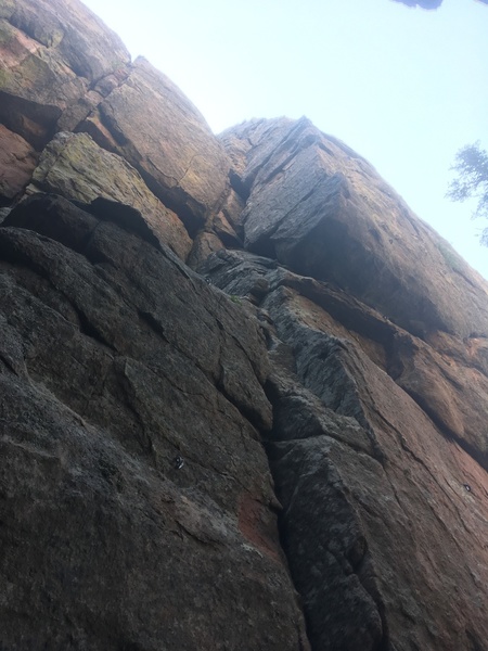 Climb past two bolts or scramble around left to jam the fun dihedral or climb the awesome arete. It is possible to switch between the two really anywhere.