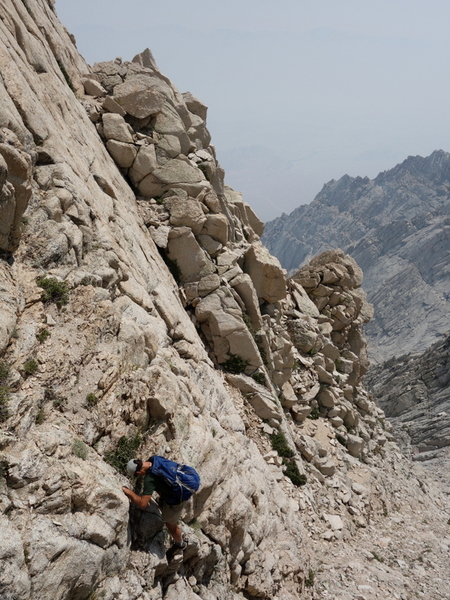 Matt on the chossy downclimb into the notch before the leaning flake