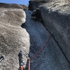 Me questing up the 5.8 crack pitch, after climbing a number of corner cracks in my time it feels comparable to like 5.10b.