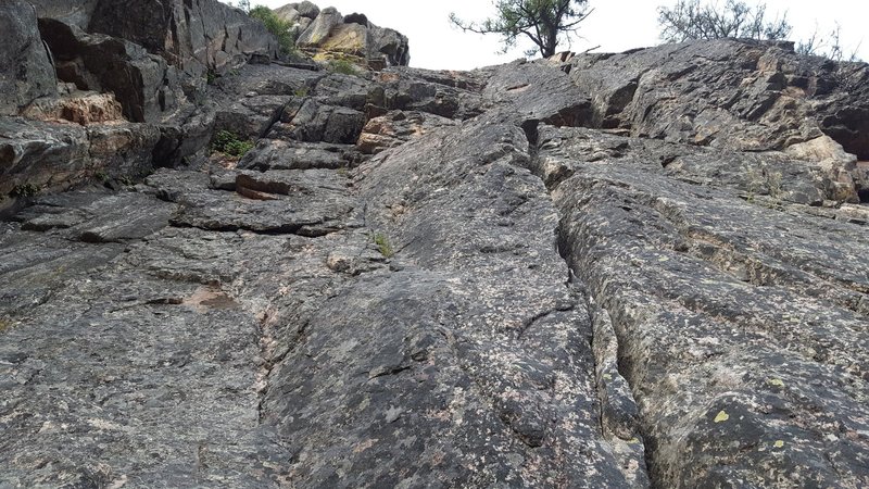 Looking up at pitch 2 from top of pitch 1. Crux of this pitch is just under the tree. Can be skipped by climbing left though.