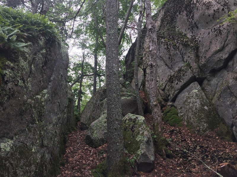 The right end of the crag with the Warm-up Boulder to the left.