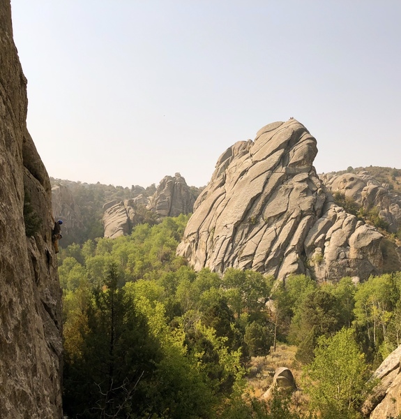 Shane Nelson cruises up Short Circuit, 5.10a while climbers atop Flaming Rock (east face) admire. Photo taken from Dynamo Hum.
