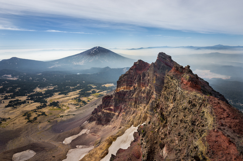 A view of the south from the peak of Broken Top, haze/smoke included during the summer of 2018. Featured: southern half of Broken Top and Mt Bachelor