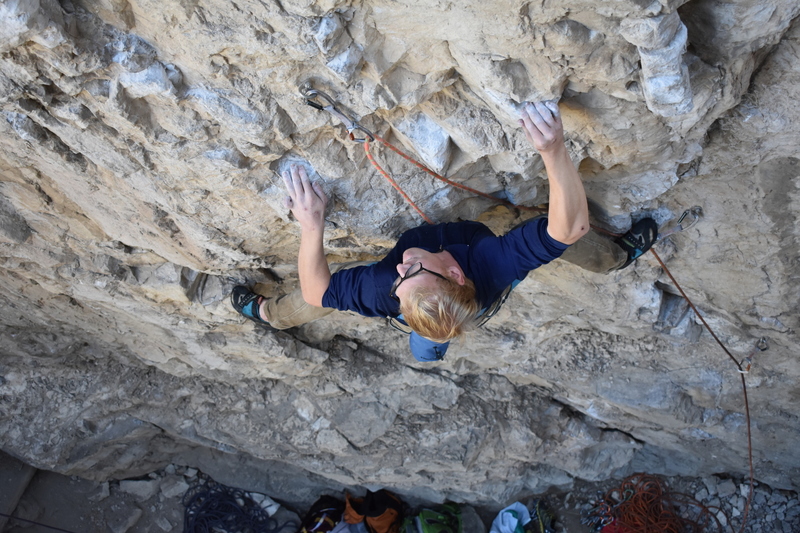 Derrick traversing into the rest before the crux.