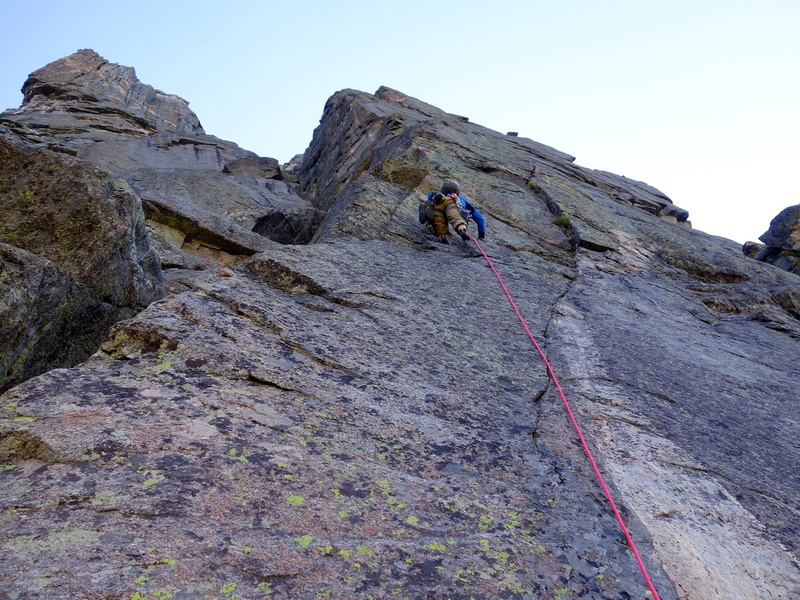 Pitch 1 of Hooven-Leo variation. To access the crack system, climb unprotectable terrain up the chimney on the left and make a committing step onto the face. From there, traverse easily to the crack system and start jamming!