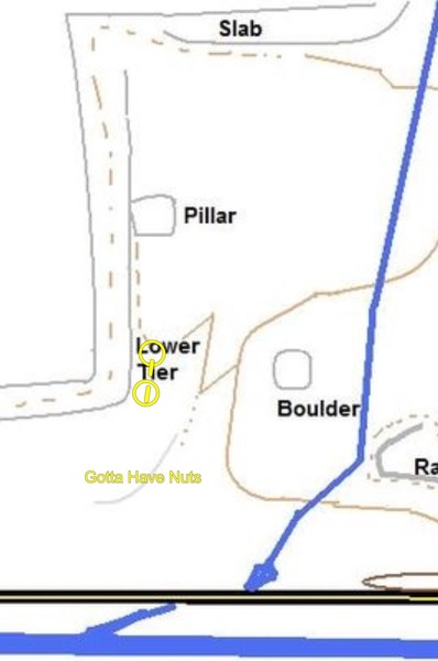 Rough location. Look for a spot on the very lowest tier kind of across from the boulder at the head of a draw with exposed slab and a horizontal band that you could climb across.
