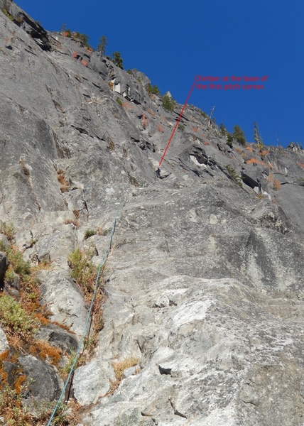 One of the 3rd class approach to the first pitch. Start from the obvious weakness in the rock (an open corner with bushes) follow a 3rd class ramp right and up to a clean corner, the start the real climbing of the first pitch. Set up your initial belay at