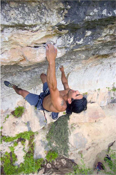 Climber hitting crux left hand pocket on route. Photo by Merrick Ales