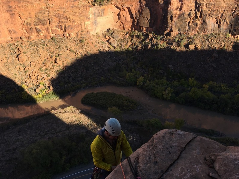 Dave Hoven rapping off the large ledge with the Dolores River in the background.