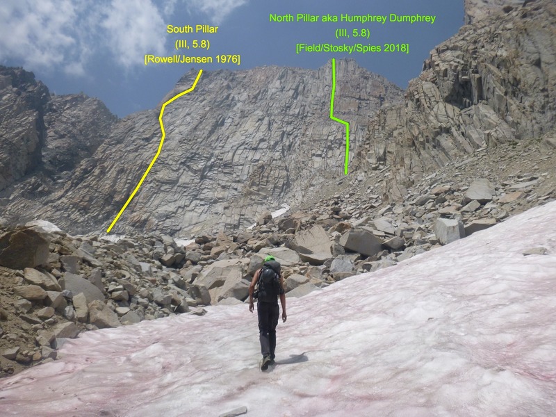 Steve approaches the massive east face of Humphreys in mid-summer conditions. Yellow and green lines show the known routes on the wall.