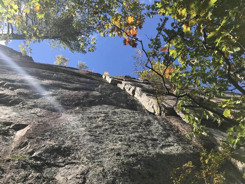 The route climbs the corner before moving out onto the face at the roof.