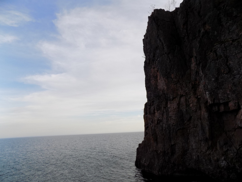 The wall at the far end of the crag, full of choss at the base
