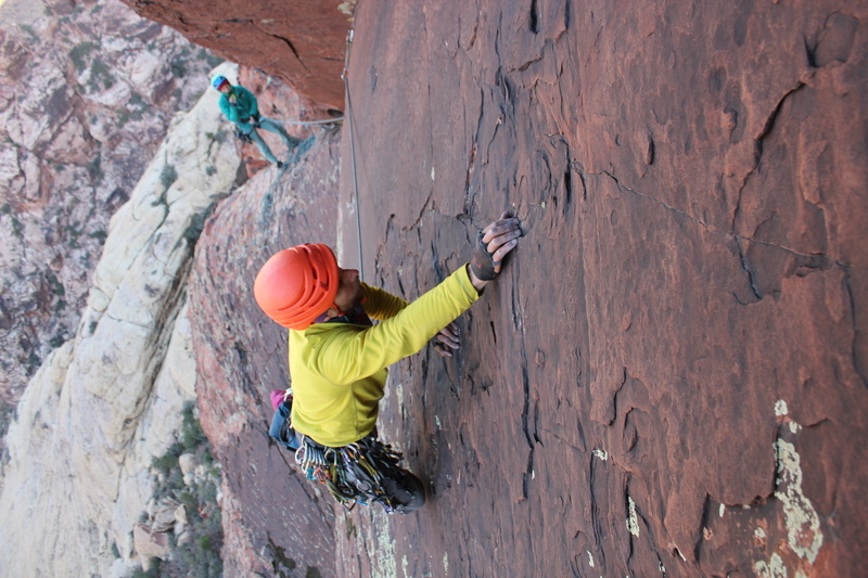 Pulling slab moves on the beautiful varnished rock of pitch 5