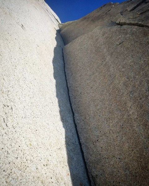 Thin finger liebacking up beautiful rock.