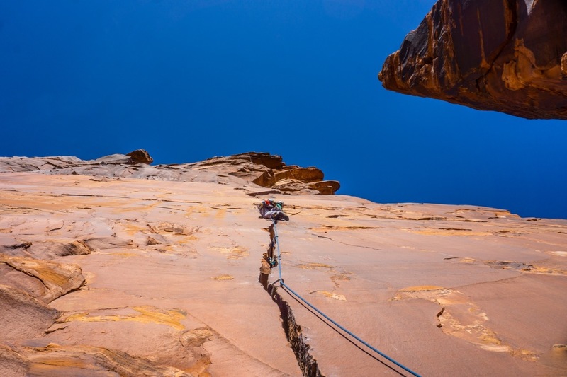 Leading up the splitter crack of "man-hands" on P3. Dolomite Spire looms to the right.