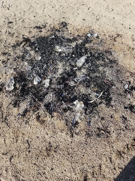 Fire left in parking lot. As you can see there are tons of nails in the fire-ring. NOT COOL!