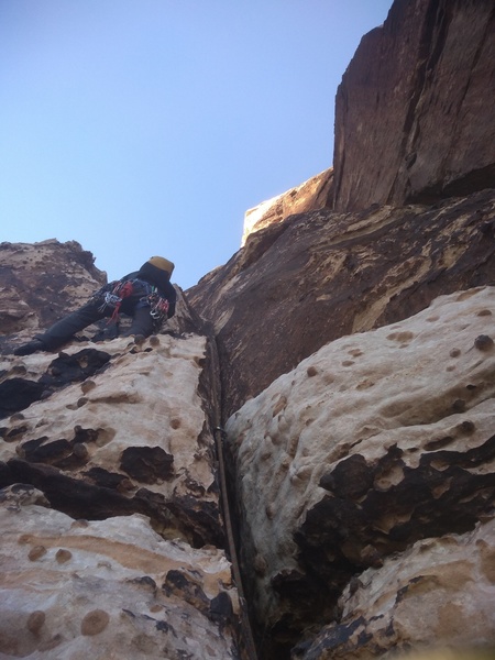 Taking off on pitch 2, after belaying to the left of the chimney on a ledge.