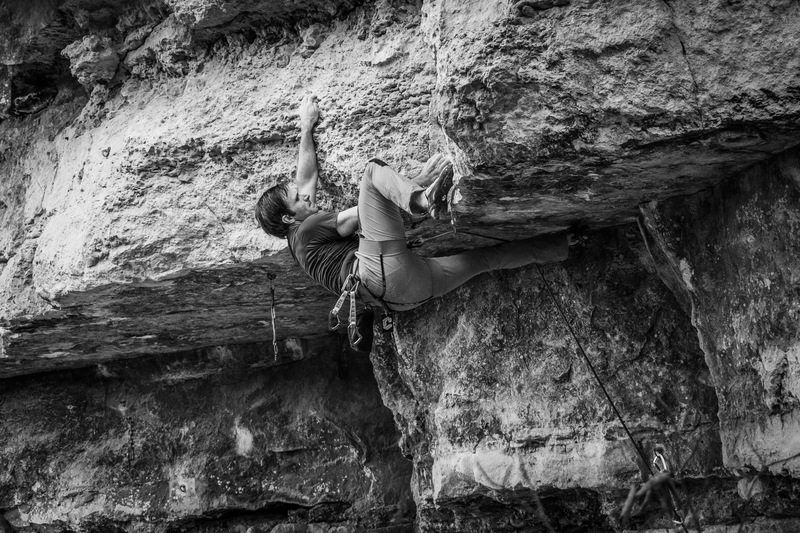 Nate executing the main crux. His left hand is on the sloppy popcorn hold that really gives this route the 12a grade