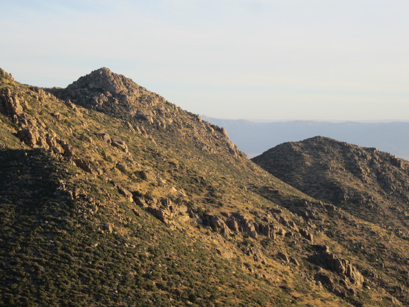 Some of the typical craggyness of the range with the Hualapai Valley and the edge of the Grand Canyon in the back.