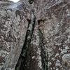 A slightly wet, slightly snowy belay at the base of "Yee Haw"