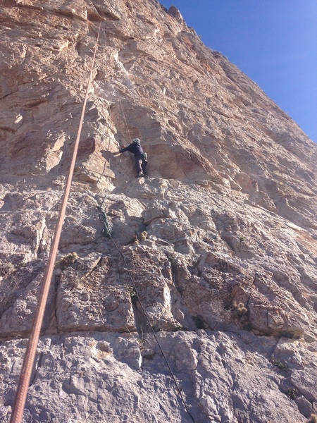 Just above the starting ledge with the first bolt and fixed line.