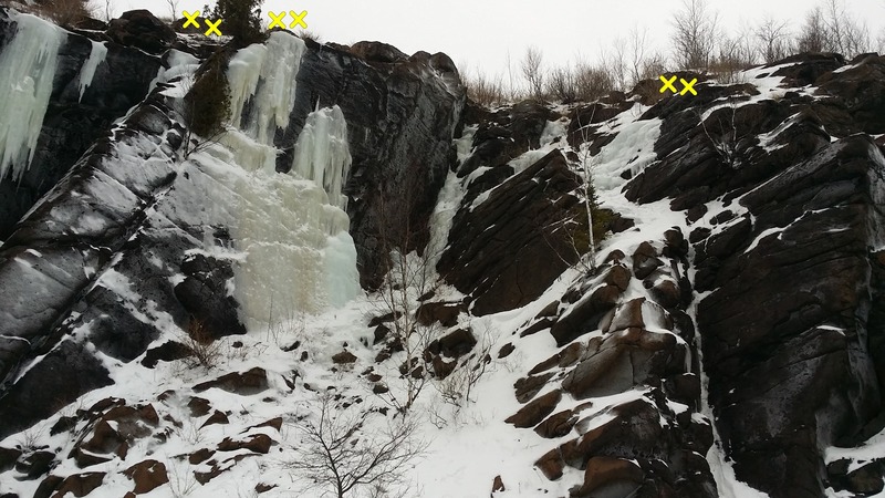 Gully in the center is WI2/3, M2/3. Head back about 30 ft at the top for trees. Ice on the left starts with slightly slabby WI3 and finishes on an acrobatic WI4/5 section. Rap anchors 20 ft back. Thin line on the right is also about WI2/3, M2/3.