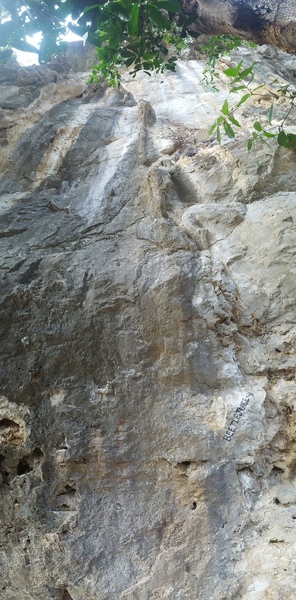 Tackle the darker rock on the left side of the photo.