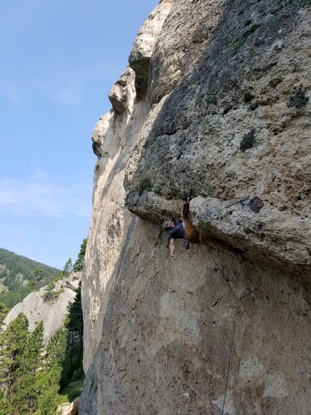 Bighorn Climbers' Coalition Prez, Alex Green, heel hooking through the Zero Chill roof.