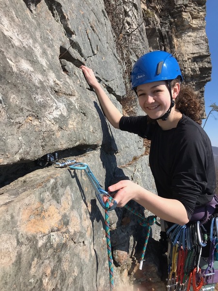 Caroline placing a bomber cam during her first trad lead on "Ribs".