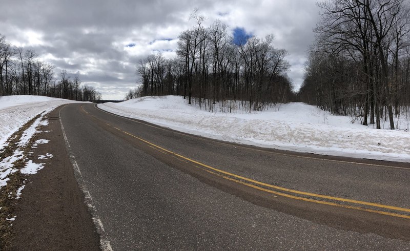 County Road W and the dirt road that leads to the trail.