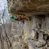 Pulling the roof on Catfish Strangler, just before the crux and just after unclipping the rope drag clip.