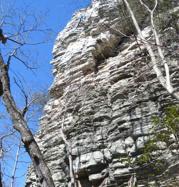 Climber going through groove in center of upper headwall.