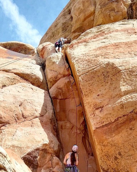 Three placements in the chimney. The anchor spot is about 10 feet behind the climber.