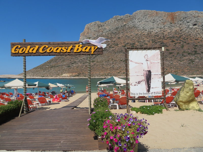 View from Stavros beach to the cliffs. The route Parthena starts at the left edge of the large cave. The supposed rap line is in the red rock to the left.