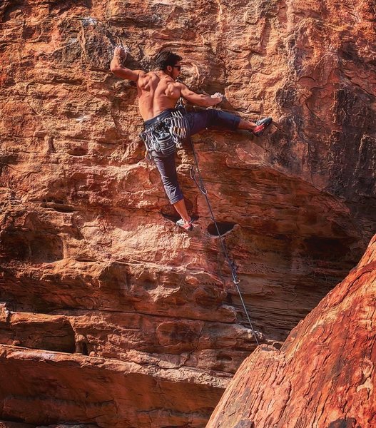 Moving out of the large hueco in front of the boulder.