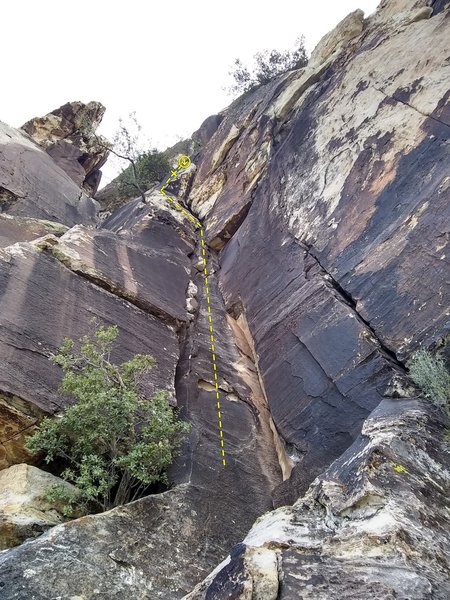 Climb goes up the corner system in the center and cuts left just above the tree up higher at some white rock.  A bolt protects the final moves up the varnished face up to a 2 bolt anchor.