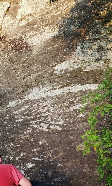 Bad photo of the problem. It's a large, hard to miss triangle boulder with a scoop like dent on the top right.