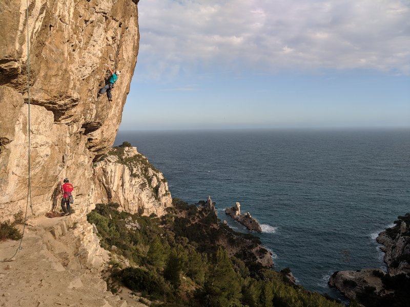 Marco climbing! Dan Belaying! We are up on the ledge, and you can see the anchor we built as the ledge is kinda thin over there.