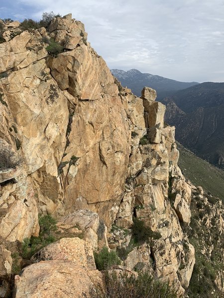 Oblique view of the Summit Area. I couldn't see any bolts on the obvious face (Irie Headwall?). I walked along the rim atop the lefthand facet and saw no anchors. The boulder that I referred to in my 2/27 comment projects upward above the rightmost facet.