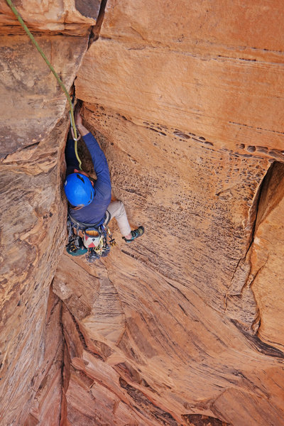 Zach on the featured rock through the steep exit to P2.
